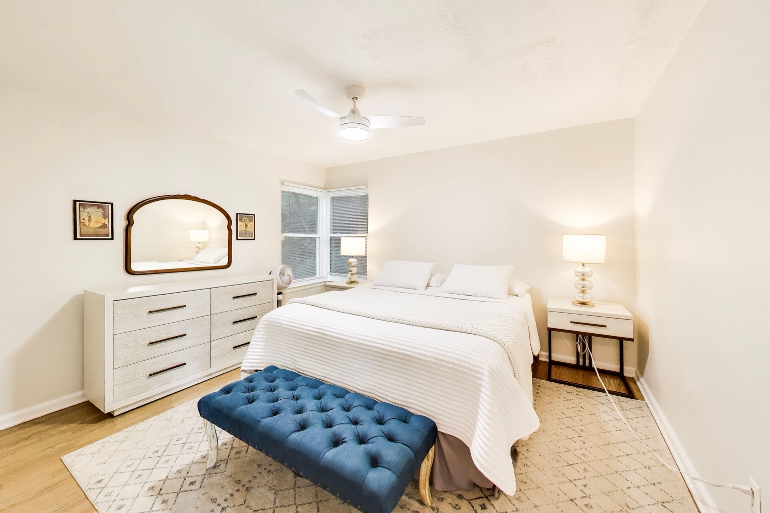 Primary bedroom at Emmet’s Place with a king bed, dresser, and upholstered bench